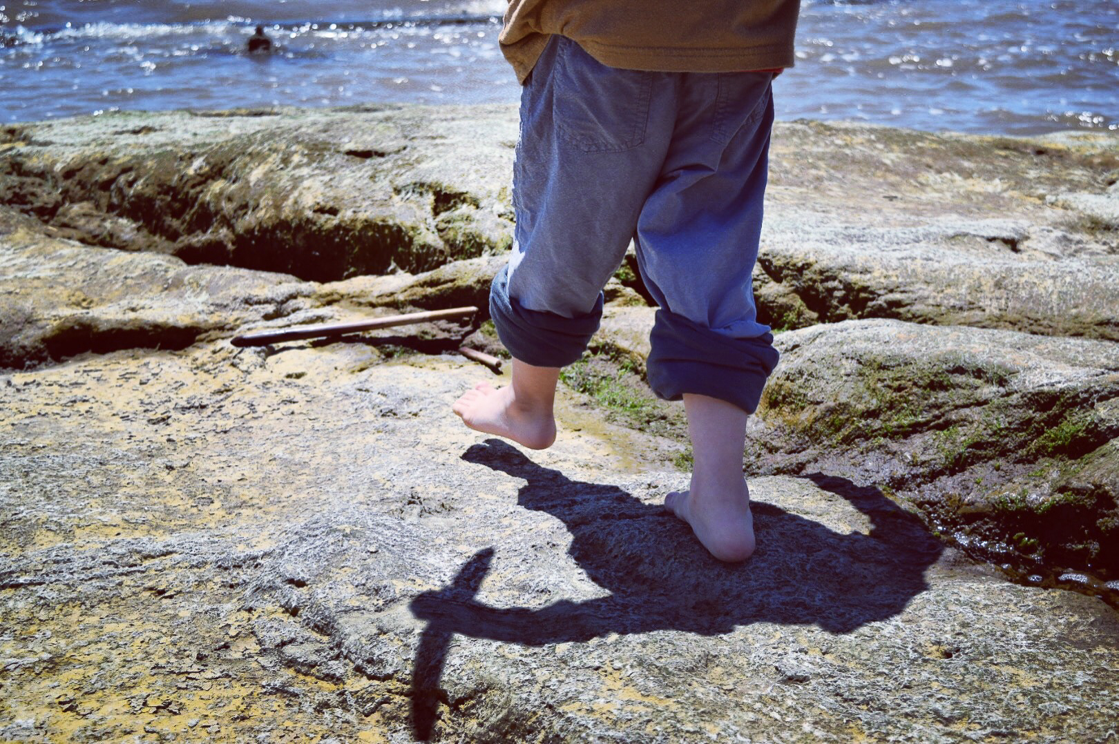 feet on a rocky beach